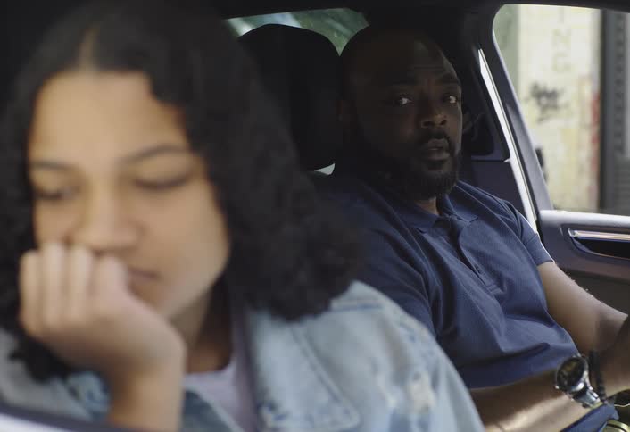 Father fighting with his daughter inside the car and then putting on her seatbelt