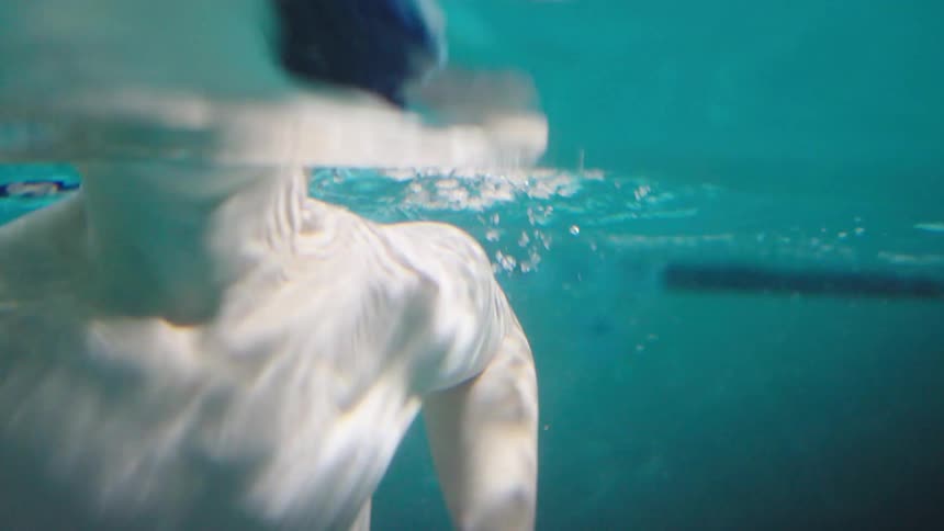 Little boy swimming in a pool