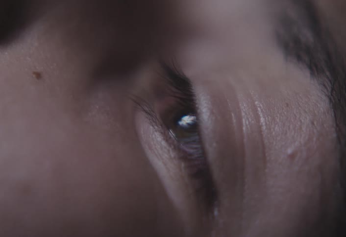 Extreme closeup of a human eye capturing intricate detail of the iris and lashes