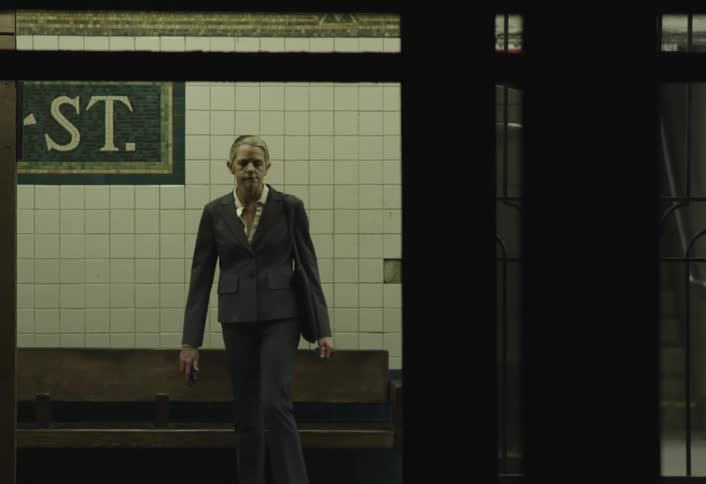 Frustrated woman sits on subway platform after missing train late for work