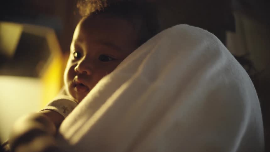 Portrait of a baby on a womans lap