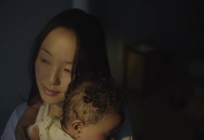 A mother is holding her baby