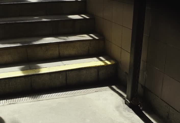 Timelapse shot of multiple peoples legs rapidly running up stairs
