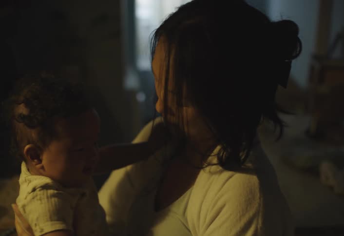Mother making her baby sleep on her lap
