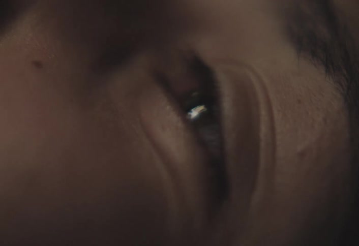 A teenage boy blinks his eyes repeatedly