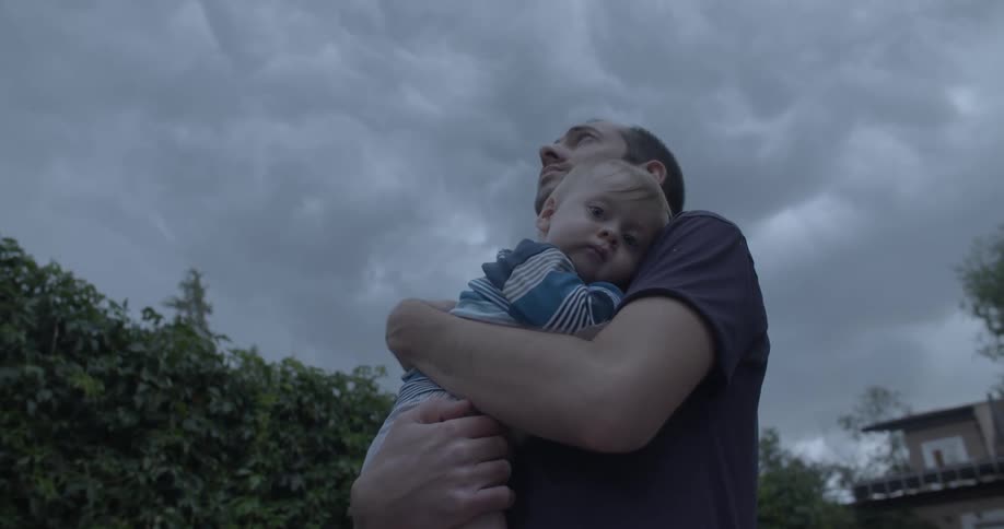 A man holding a baby in his arms