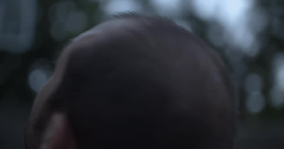 A man holding a baby in his arms looking at the sky