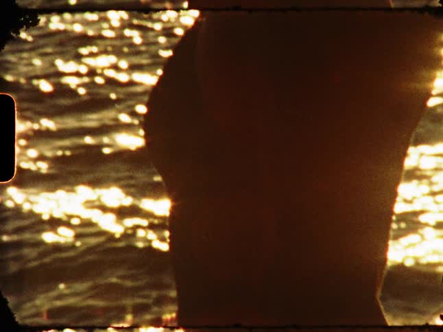 A woman on the beach in a bikini playing with her hair