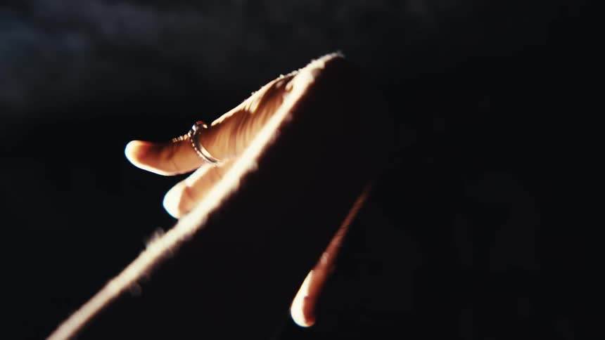 Water drips on a womans hand in the cave