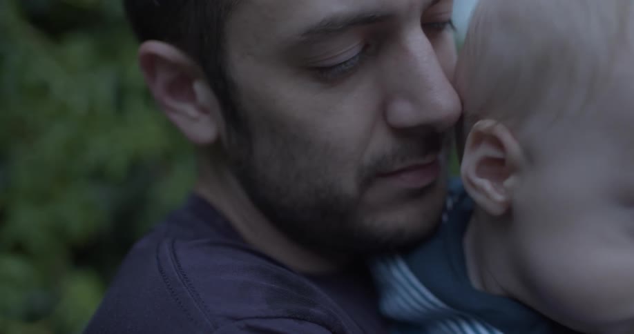 A father holds his son tight