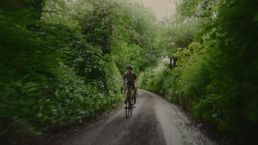Female cyclist riding along a trail