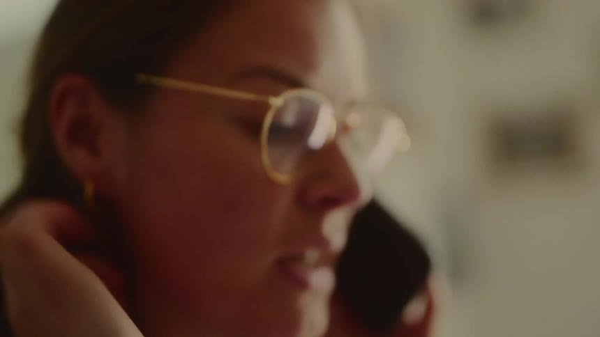 Woman with glasses talking on the phone