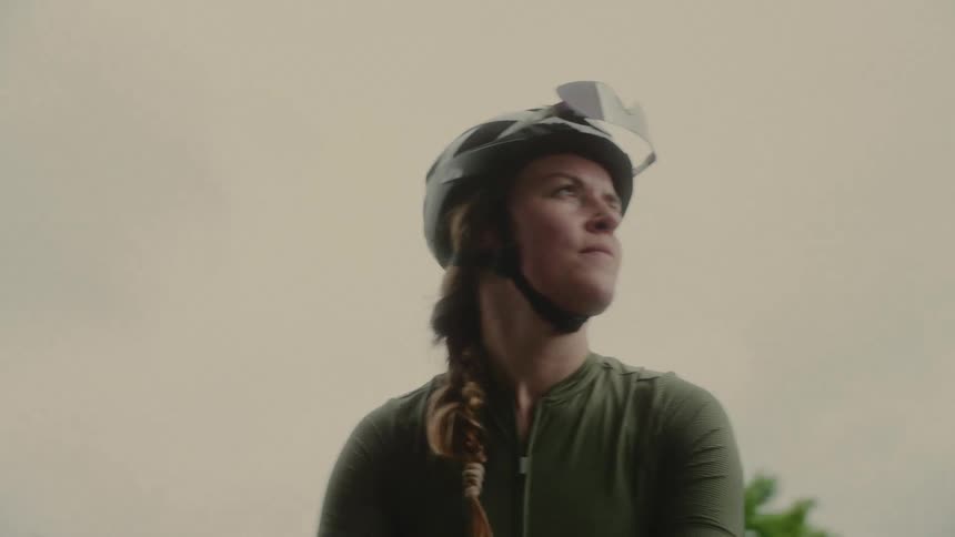Woman cyclist wearing helmet outdoors