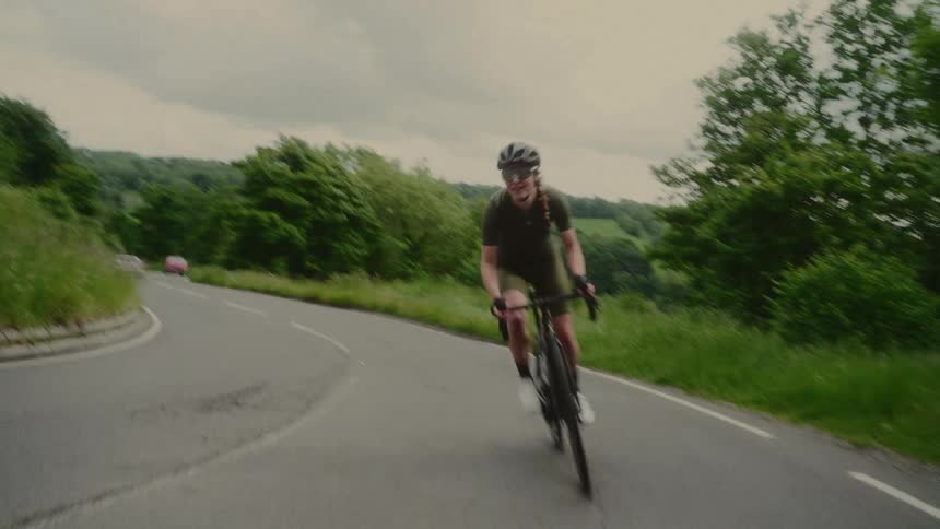 A woman rides her bicycle on the road