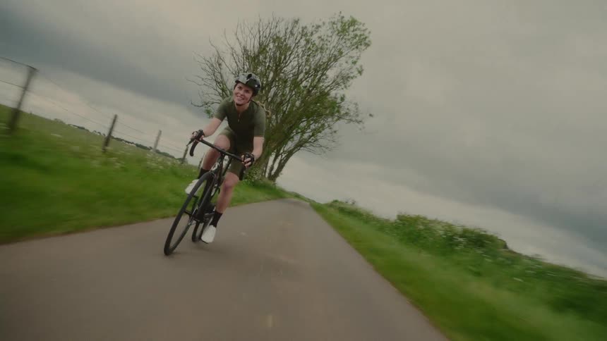 A woman riding a bike down a street