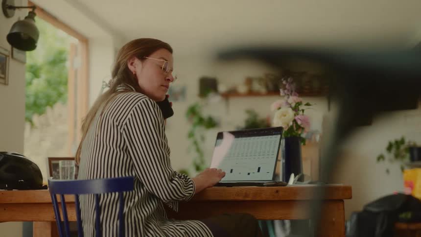 A woman turns from her desk