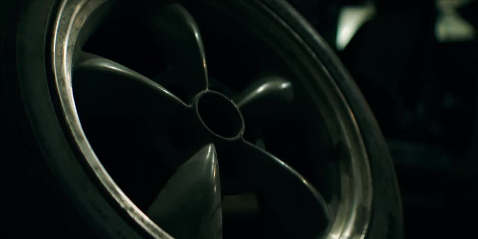 Wheel with tire of a vehicle in a workshop garage