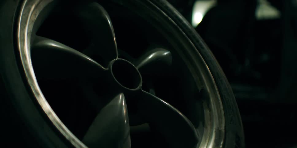 A wheel is leaning in the garage