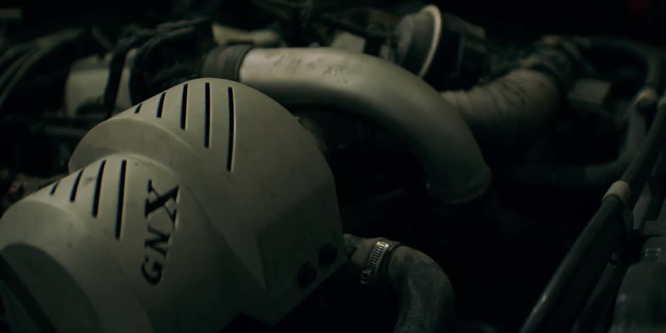 A closeup shot of a car engine with a visible gmxlabeled air intake component