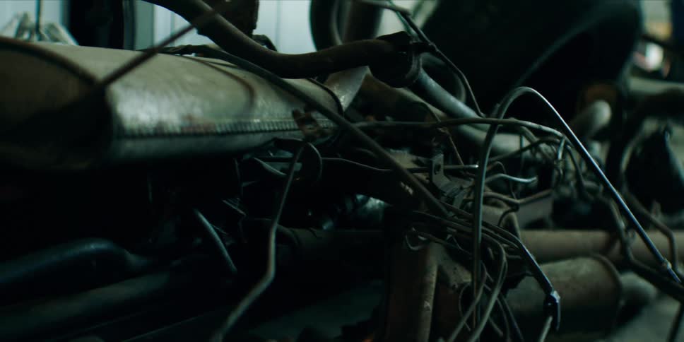 A pile of old auto parts sit in the garage