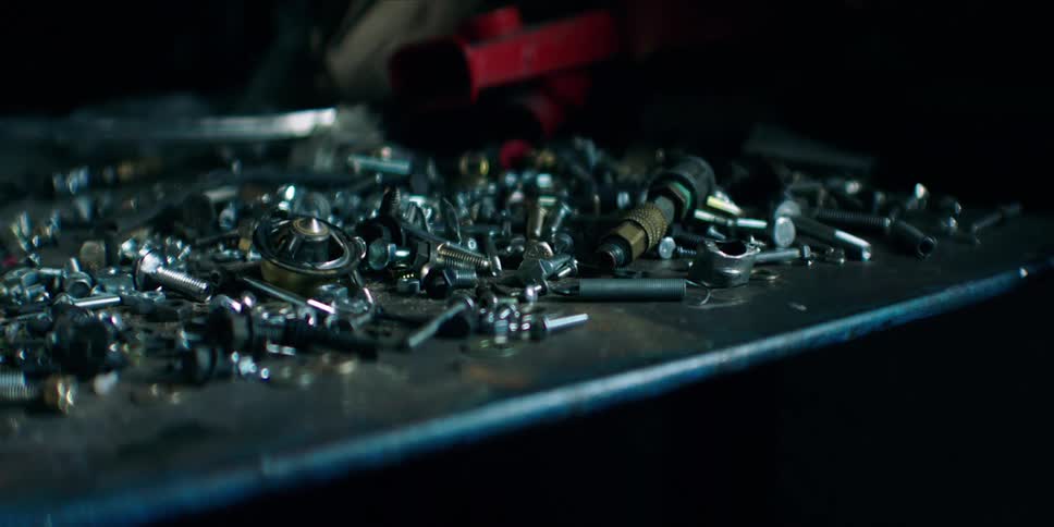 Close up of screws of different sizes on a metal surface