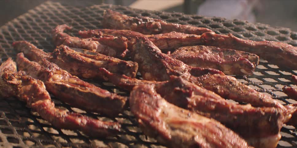 Meat is cooking on the grill outside