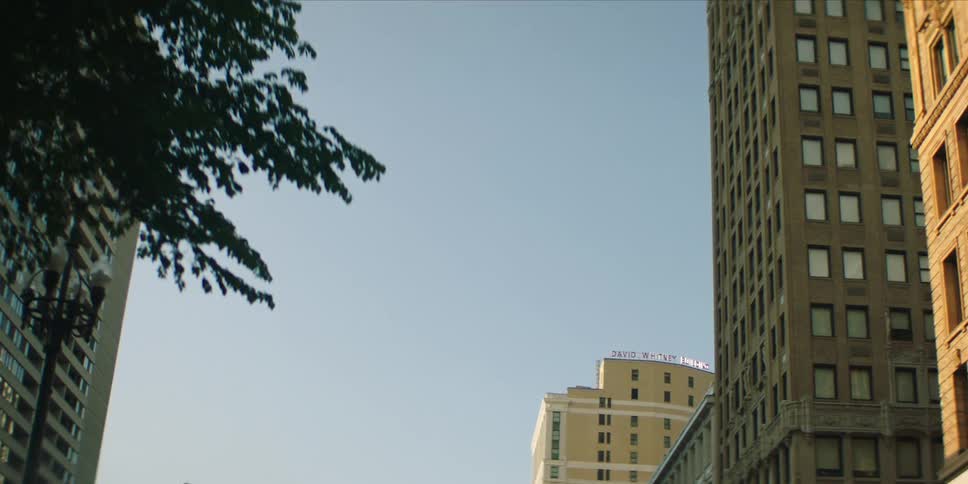 Upward and moving view of buildings in a metropolis during the day