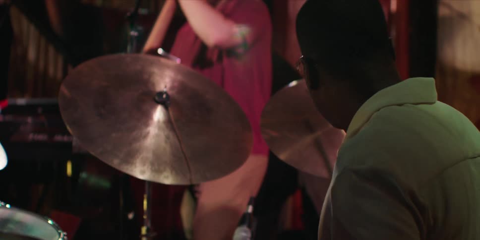 A black drummer passionately playing the drums during a concert performance