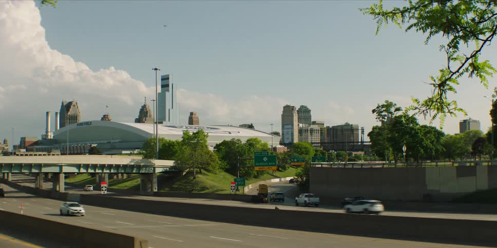 Traffic moves along the highways passing downtown on a cloudy summer day