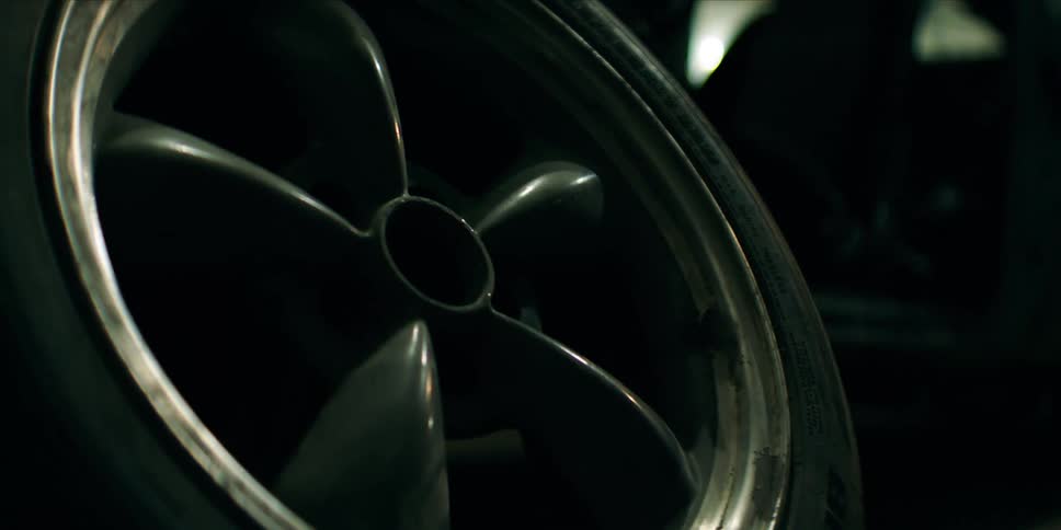 A tire is in the dark garage