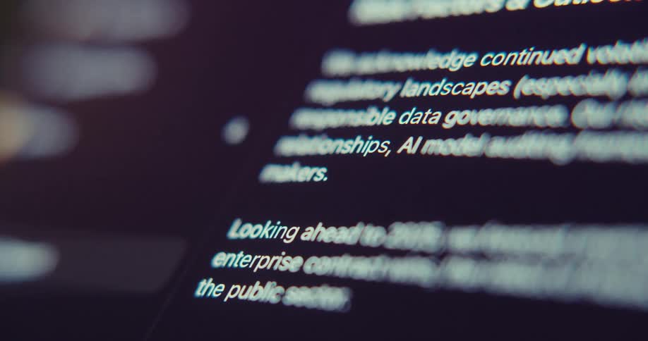 A closeup of some blurry text on a dark screen which appears to be a presentation slide
