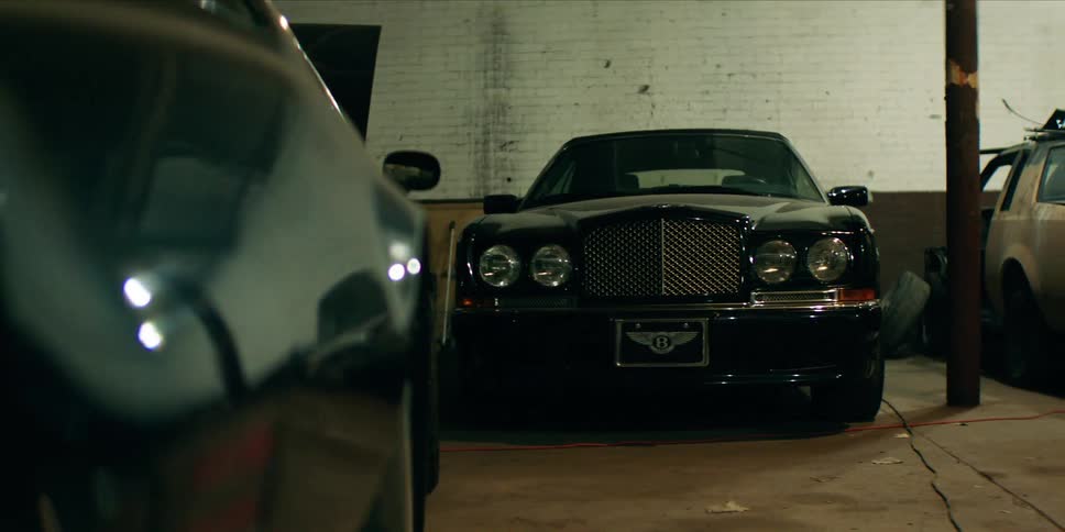 Three cars in an auto repair shop