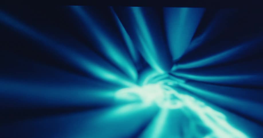 Blue light rays radiate in an abstract blurred pattern across a dark background