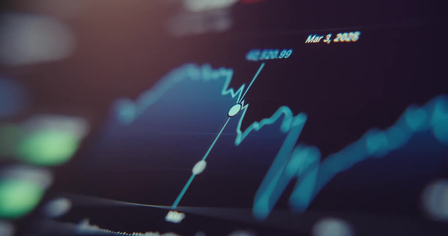 A closeup digital screen displays a fluctuating stock or financial chart