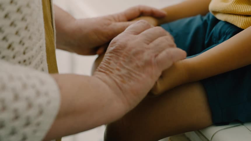 A woman puts an item into a boys hand