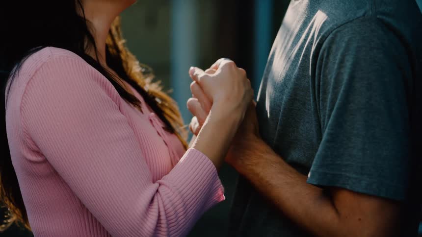 A man and woman dance together outside