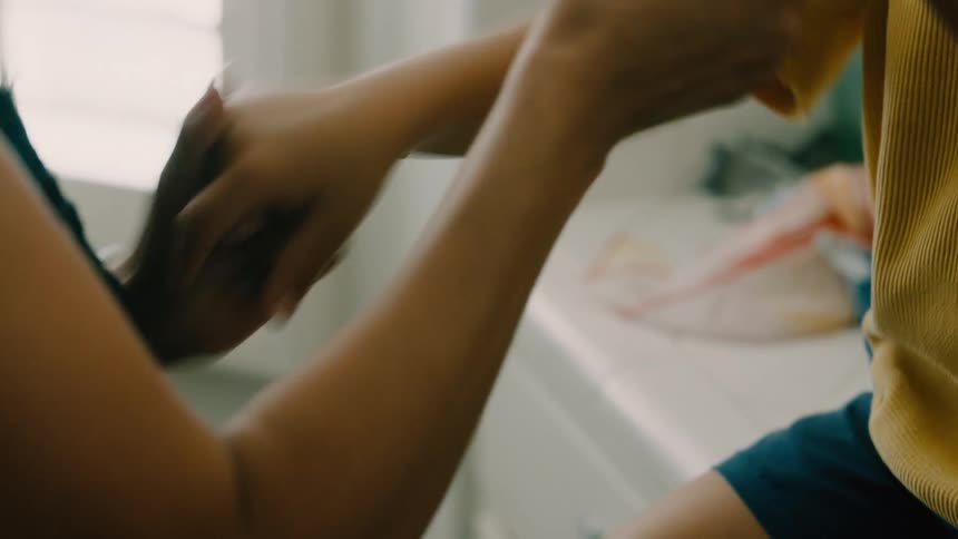 A mother and son holds hands and play