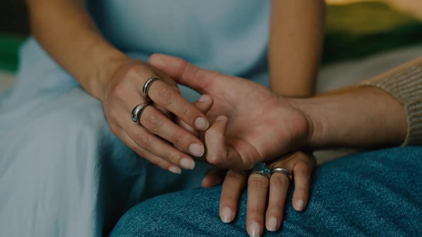 A man and woman touch hands