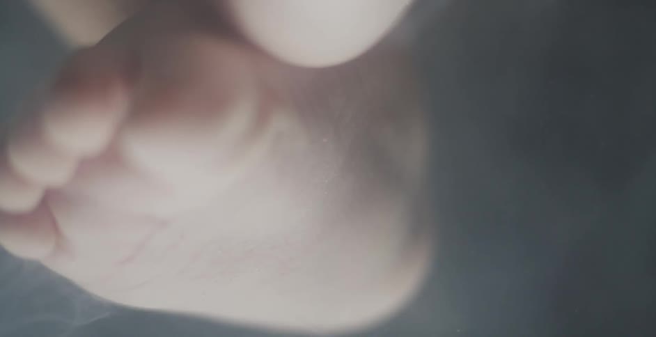 A babies feet moves around in smoke