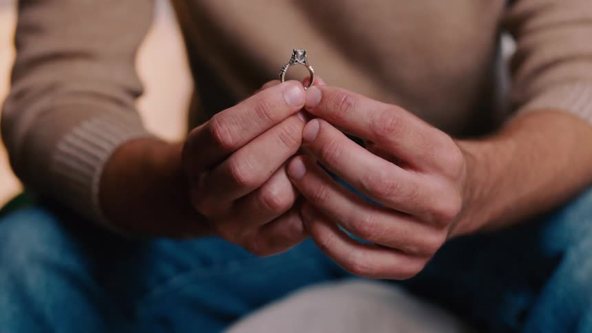 Man holding a diamond ring begins to shake