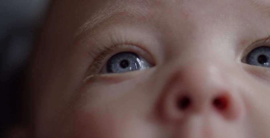 A baby is looking around with eyes wide open