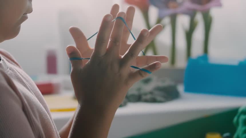 Children are playing with a rubber band