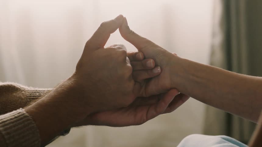 A man and woman hold hands