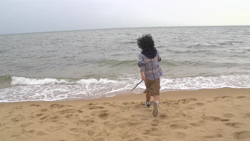 A person running towards the water