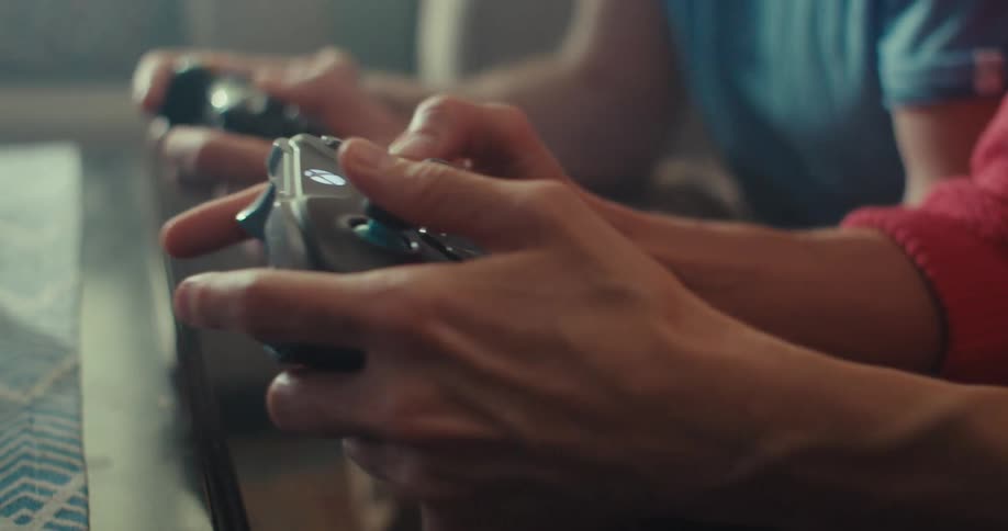 A man and woman are excited while playing video games