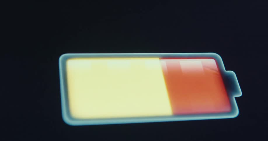 Close up of a charging battery icon with a dark background on a device screen