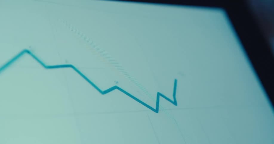 A bright blue line graph moving across a light blue screen