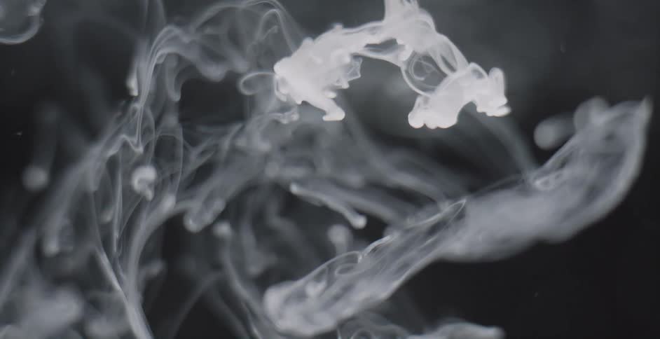 Smoke moves around a dark area