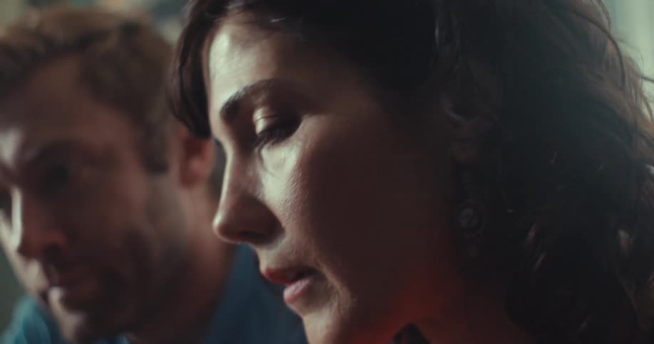A woman is talking as a man listens