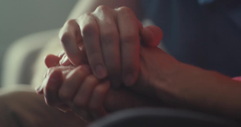 Two friends are holding hands together